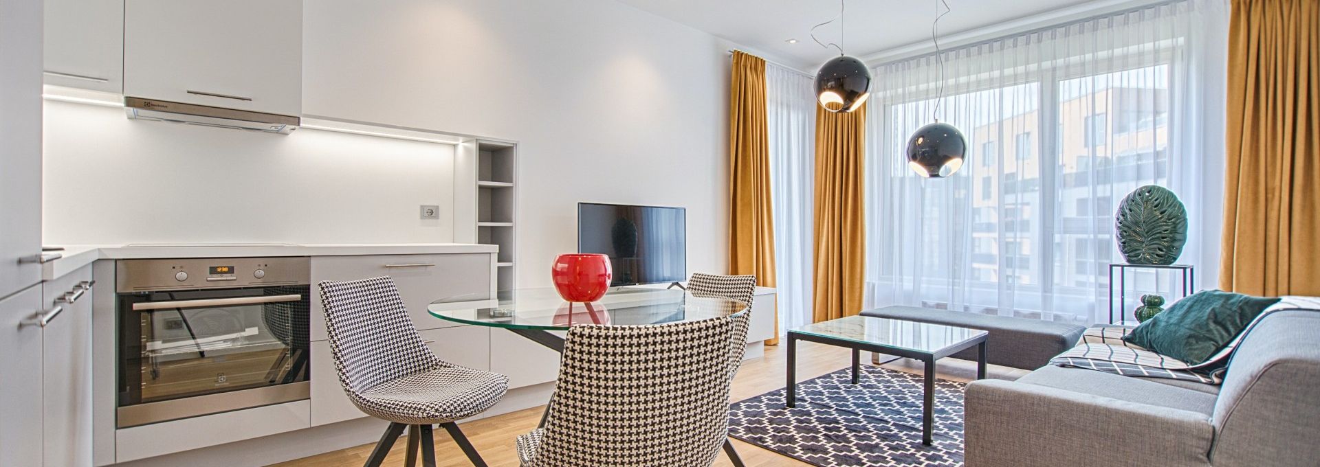 two chairs with glass table on living room near window 1571453